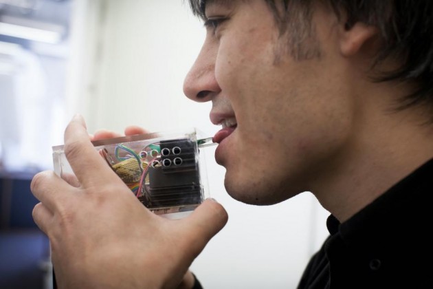 Australian scientist Adrian Cheok uses one of his devices, which aim to move technology beyond mere information. Photograph: Sophie Gost